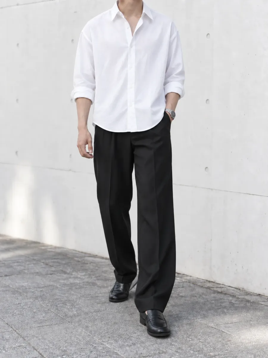 白シャツに黒のスラックスとローファーを合わせた男性の服装